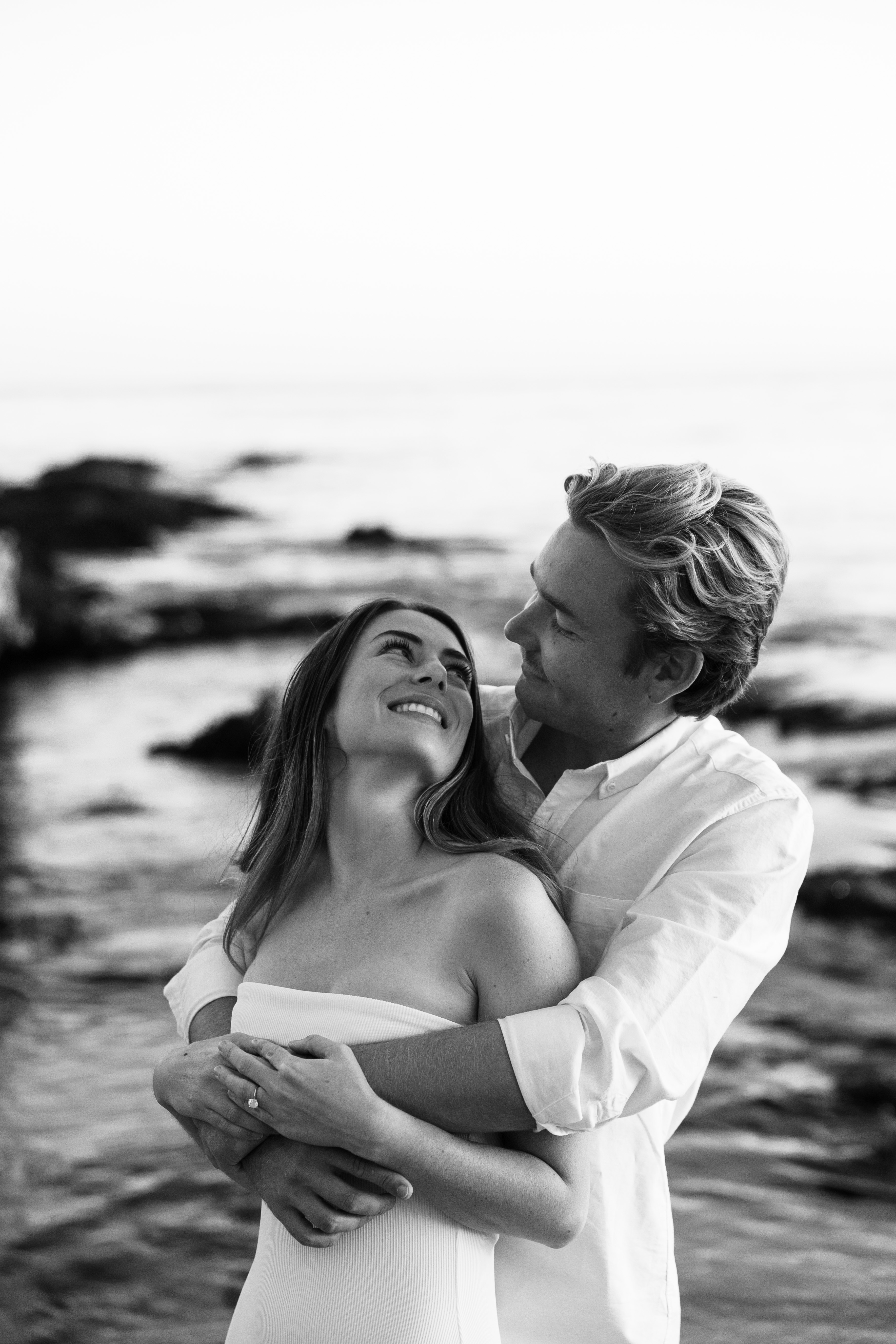 Brianna and Christopher embracing at the beach